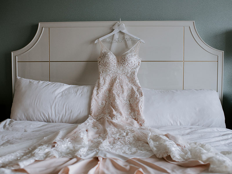 wedding dress on bed