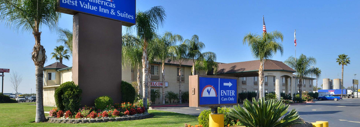 Hotel exterior with sign and palm trees