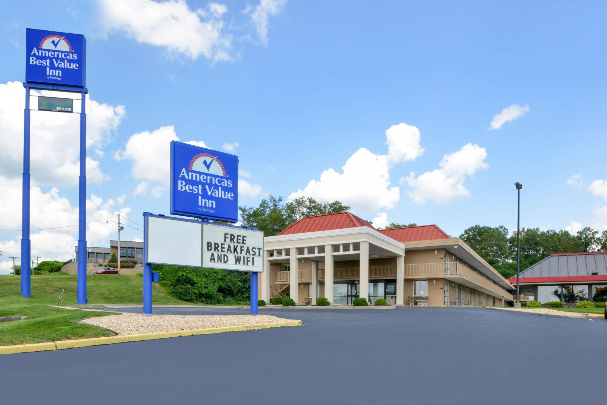 Street view of hotel exterior with sign