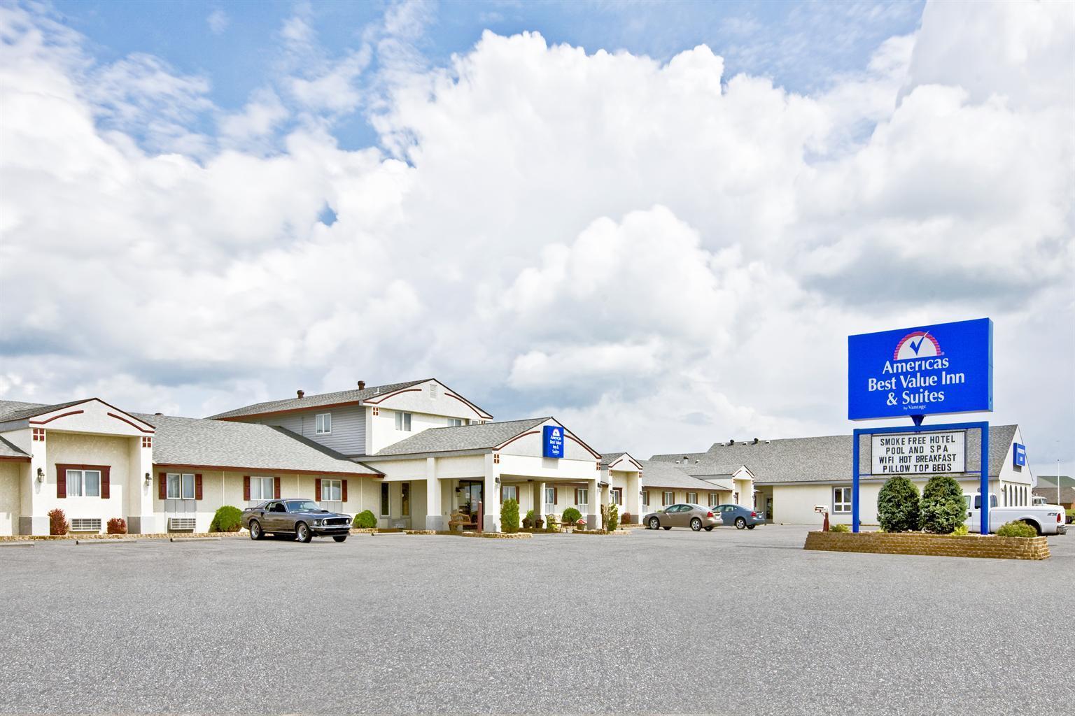Hotel exterior with parking lot and sign