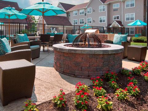 Fire pit, outdoor seating area, and pool area at Sonesta ES Suites Allentown Bethlehem Airport.