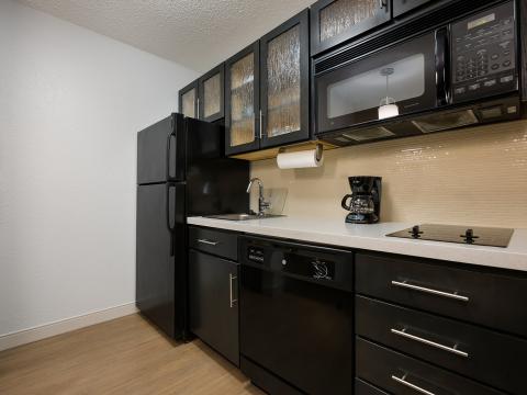 The kitchen area of the One Bedroom Suite at Sonesta Simply Suites Huntsville Research Park.