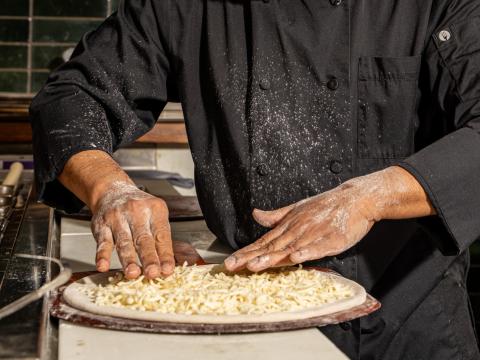 A chef making a pizza at Certo! restaurant in Washington, D.C.