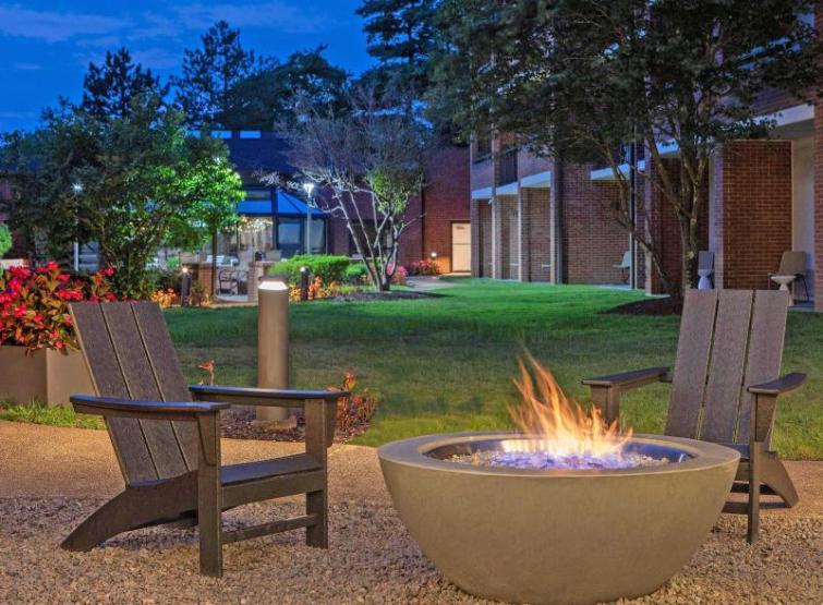 Sonesta Select 3,000 Bonus Point Offer teaser image showing Adirondack chairs around an outdoor gas fire pit.